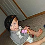baby, child, indoor, carpet, toy, cap, hat, diaper, floor, door, walls, person, sitting, curious, blue_eyes, clothing, hand, foot, play, casual