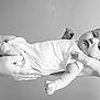 Audrey joined the competition — help win amazing prizes! baby, infant, hands, tattoo, black_and_white, portrait, newborn, clothing, person, skin, arm, cute, lying_down, gentle, support, human, face, expression, calm, monochrome