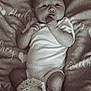 Audrey joined the competition — help win amazing prizes! baby, infant, onesie, blanket, heart_pattern, crocheted_booties, cute, lying_down, hand_in_mouth, portrait, indoor, soft_texture, newborn, sleepwear, cozy, curious, child, monochrome, peaceful, face