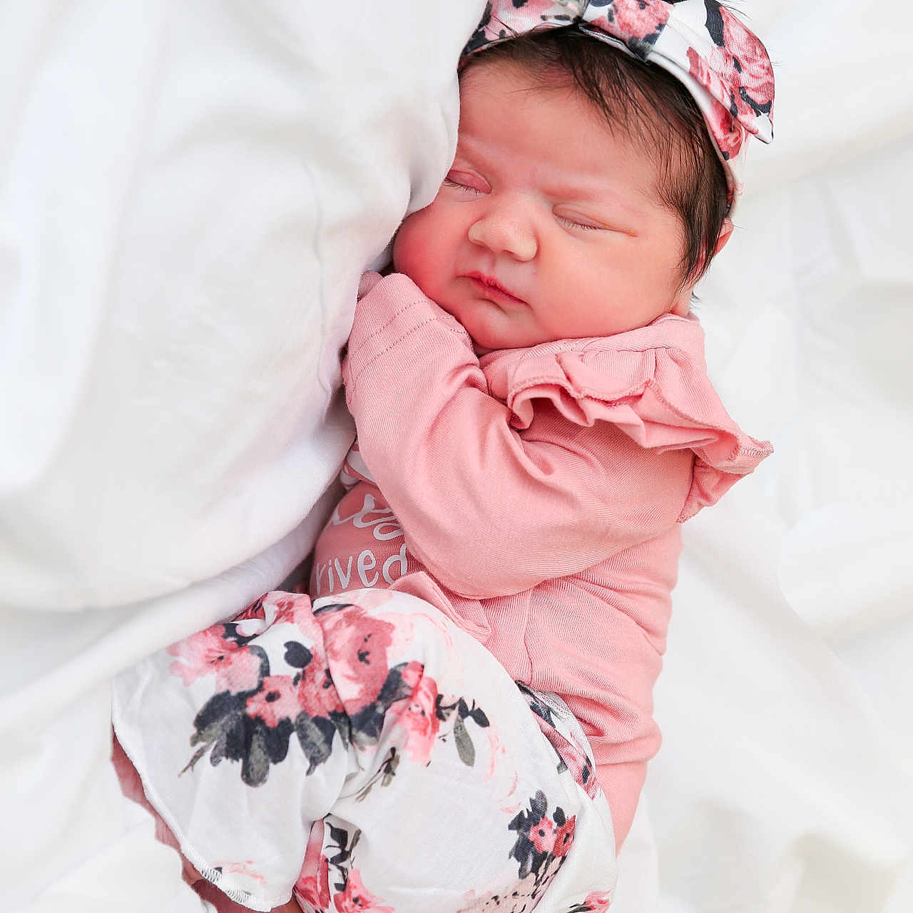 Everleigh joined the competition — help win amazing prizes! baby, child, closed_eyes, cozy, cute, floral_pattern, hair, headband, indoors, infant, lying_down, newborn, peaceful, pink_clothing, portrait, resting, skin, sleeping, small_hands, soft_bedding