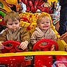 Eva a rejoint le concours — aidez-le/la à gagner de superbes lots ! amusement_park, amusement_ride, arcade, bright_colors, child, colorful, entertainment, family, fun, happy, indoor, jacket, pacifier, person, playful, smile, steering_wheel, toddler, toy_car, young_children
