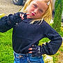 child, girl, blonde_hair, fingerless_gloves, black_sweater, blue_jeans, outdoor, grass, car, posing, playful, pouting, hair_clips, nature, casual_clothing, young_person, fashion, confident, portrait, daylight