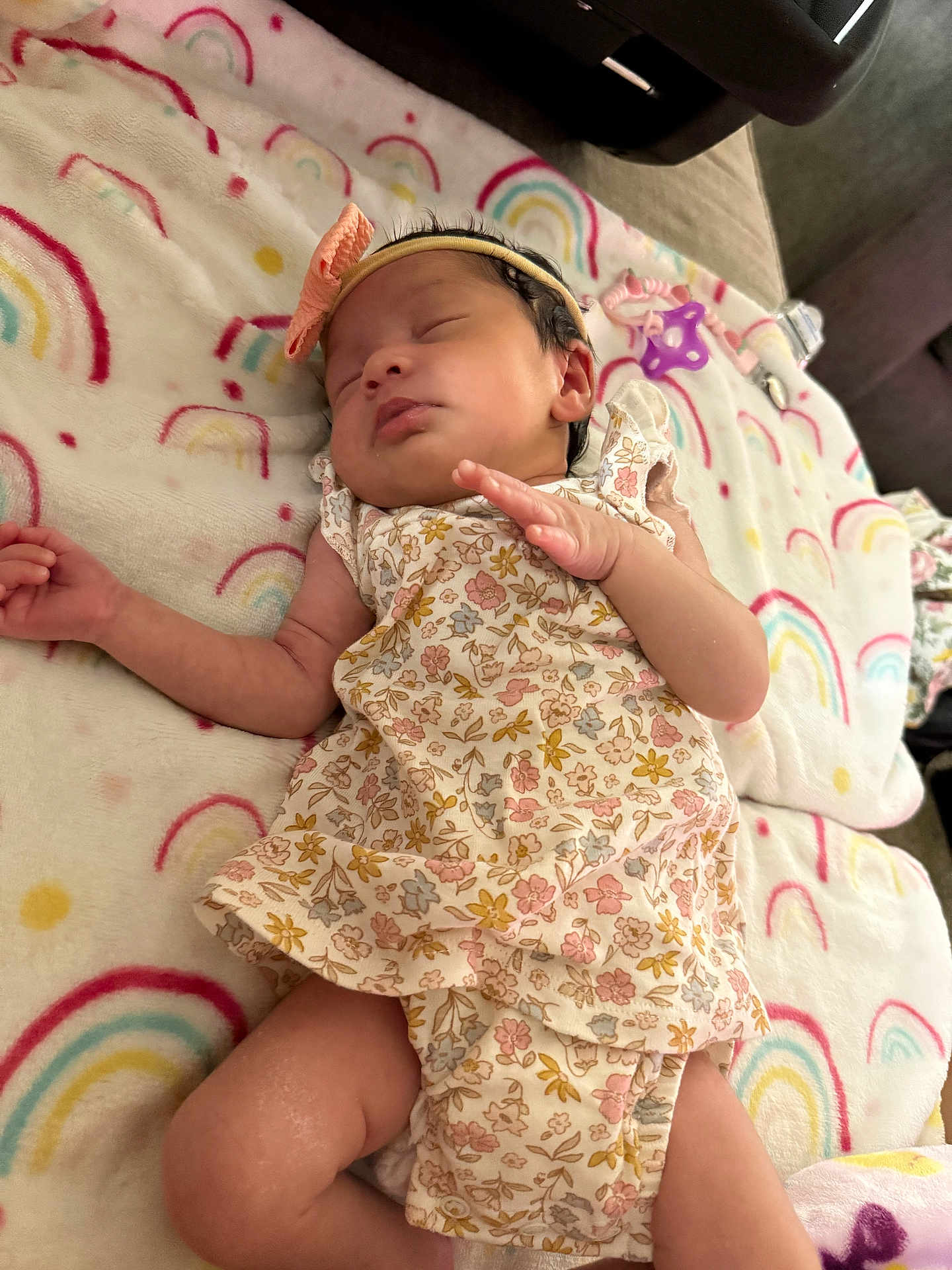 Brylie joined the competition — help win amazing prizes! baby, newborn, sleeping, floral_outfit, headband, bow, blanket, rainbow_pattern, infant, cute, resting, soft_texture, peaceful, child, indoors, fabric, clothing, hand, leg, face