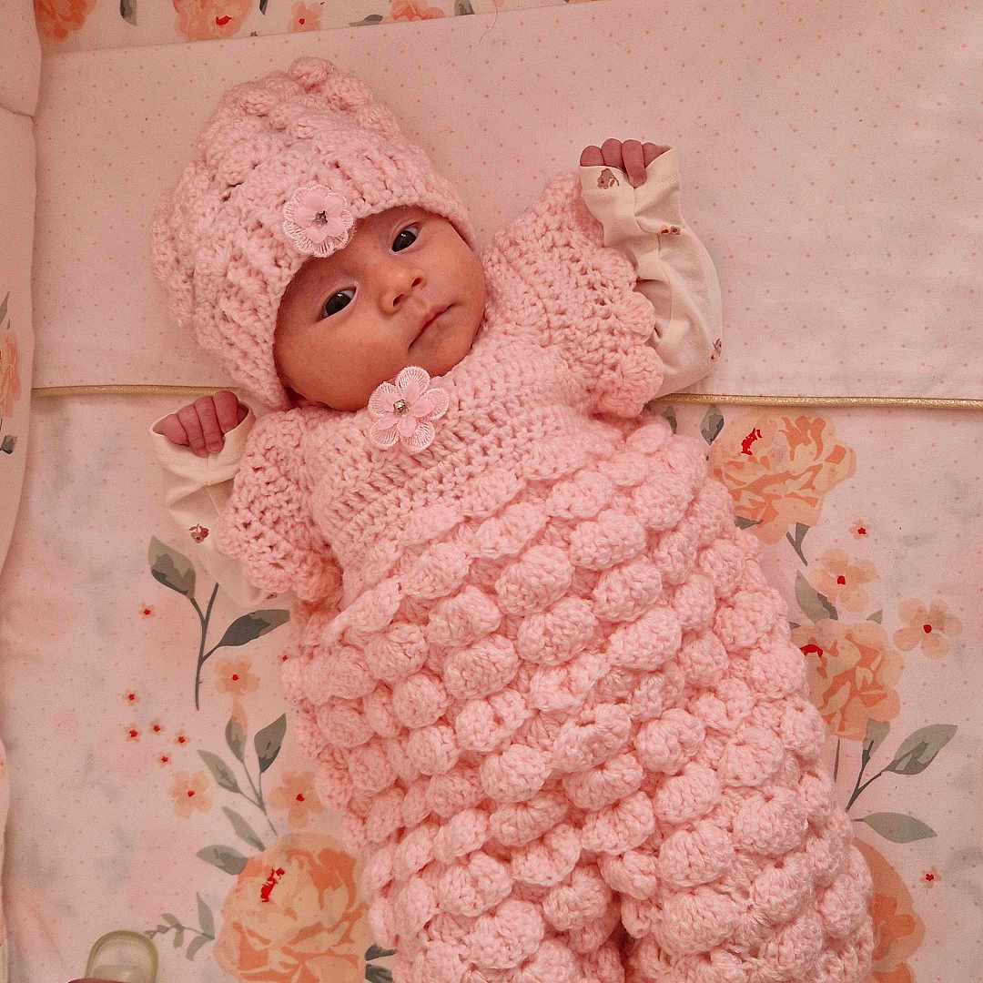 Ana-Khuslen participe au concours pour gagner de l'argent avec cette photo : baby, bedding, blanket, crib, crocheted_outfit, cute, floral_bedding, hand, hat, infant, lying_down, newborn, nursery, pacifier, pink, plush_toy, portrait, socks, toy, wide_eyes