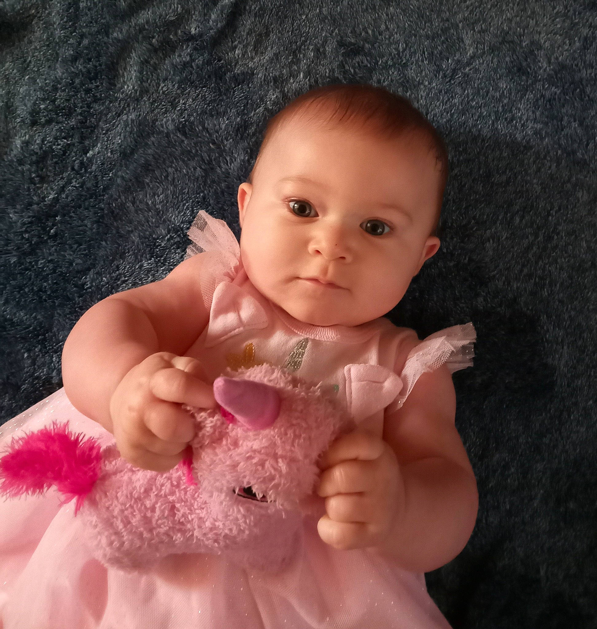 Kaelyanna is registered to the contest to win money with this photo: arm, baby, baby_toddler_clothing, cheek, chest, dress, eye, eyebrow, face, finger, gesture, hair, head, iris, leg, lip, nose, person, pink, skin