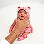 baby, infant, hand, knitted_hat, pink_clothing, cute, newborn, tiny_feet, soft_background, portrait, human, child, support, comfort, expression, small, cuteness, warmth, adorable, skin