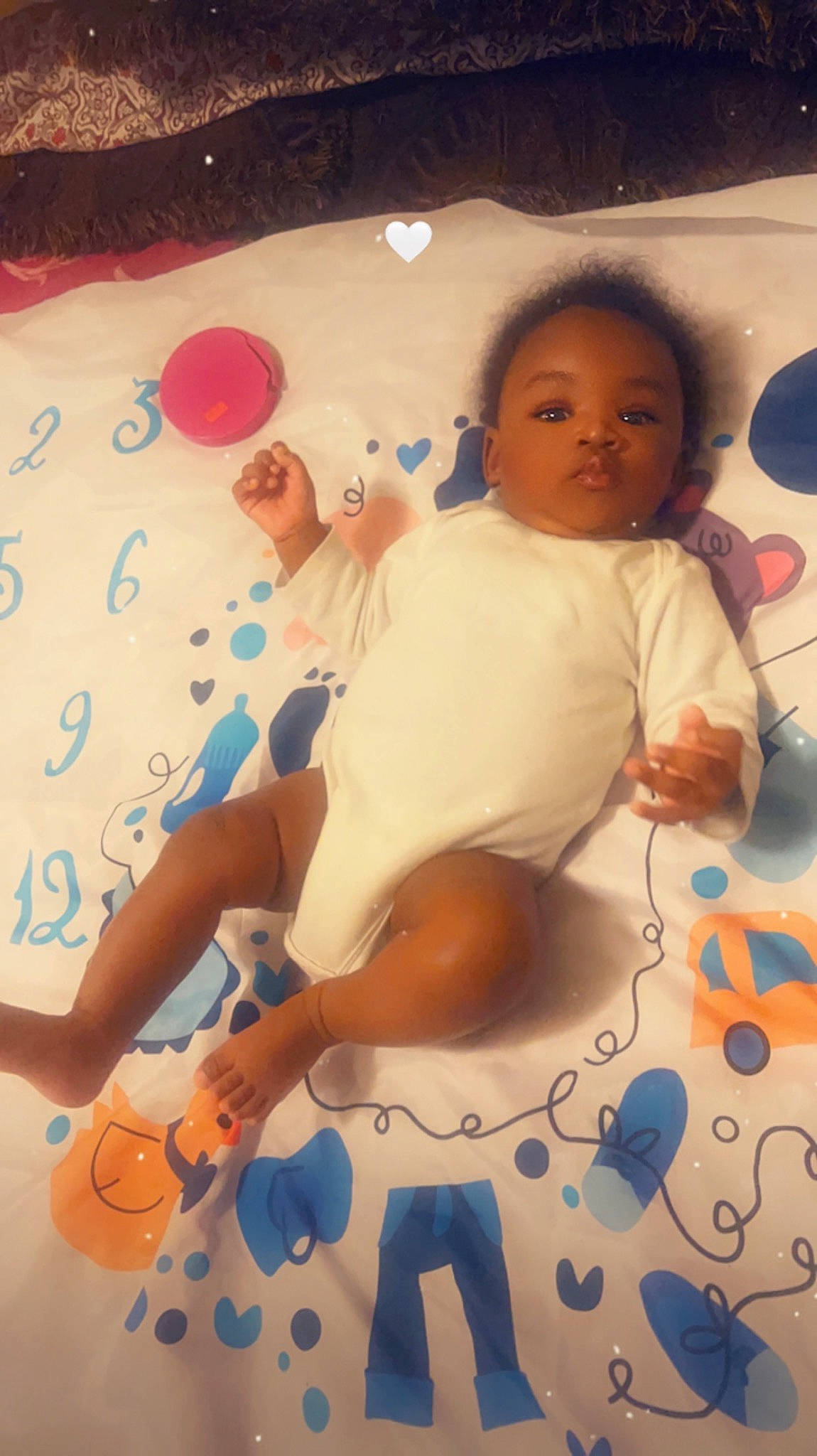 Cayden is registered to the contest to win money with this photo: arm, baby, baby_products, bathing, child, facial_expression, finger, flooring, fun, happy, joint, person, play, product, room, skin, stuffed_toy, textile, thigh, toddler