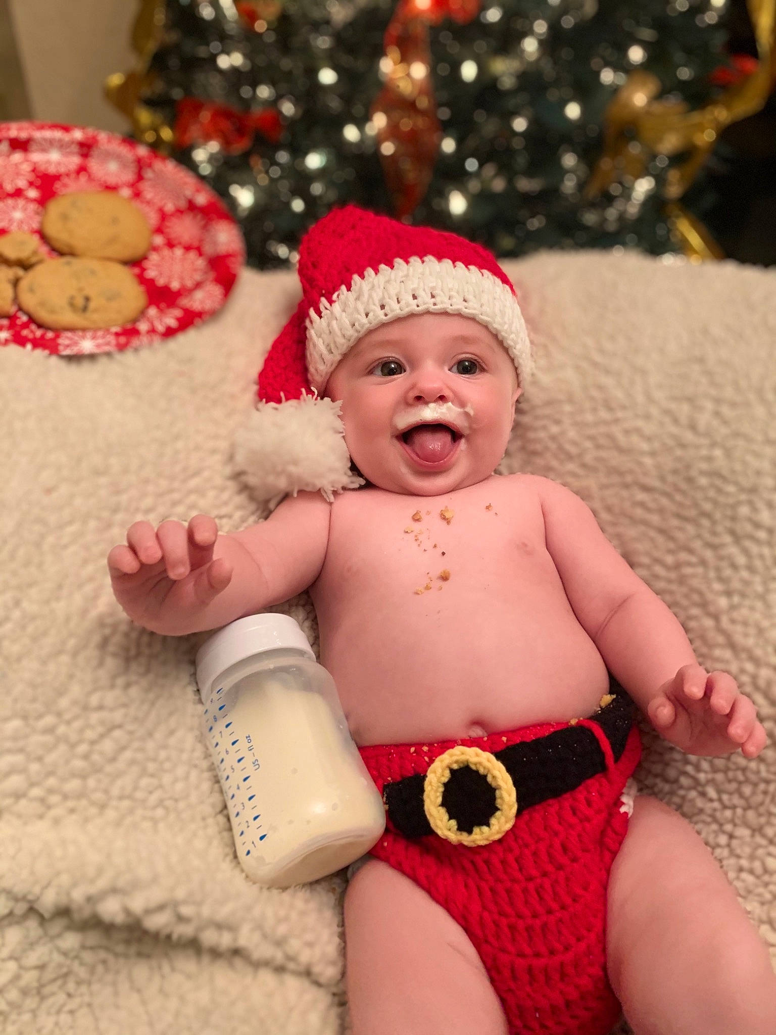 Xavier joined the competition — help win amazing prizes! baby_toddler_clothing, cap, christmas_tree, finger, happy, hat, head, headgear, headwear, holiday, human_body, leg, light, organ, person, pink, red, skin, smile, thigh
