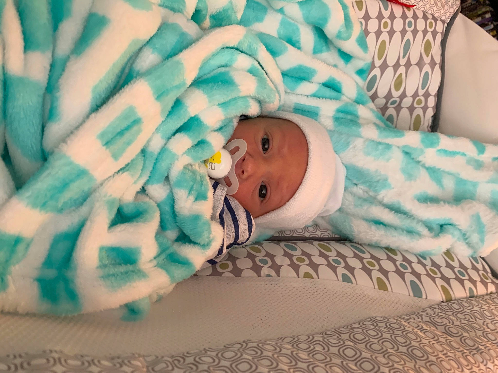 Xavier is registered to the contest to win money with this photo: azure, baby, baby_products, baby_safety, baby_sleeping, baby_toddler_clothing, bed_sheet, bedding, bedtime, child, comfort, face, grass, hat, headwear, linens, nap, pattern, person, room