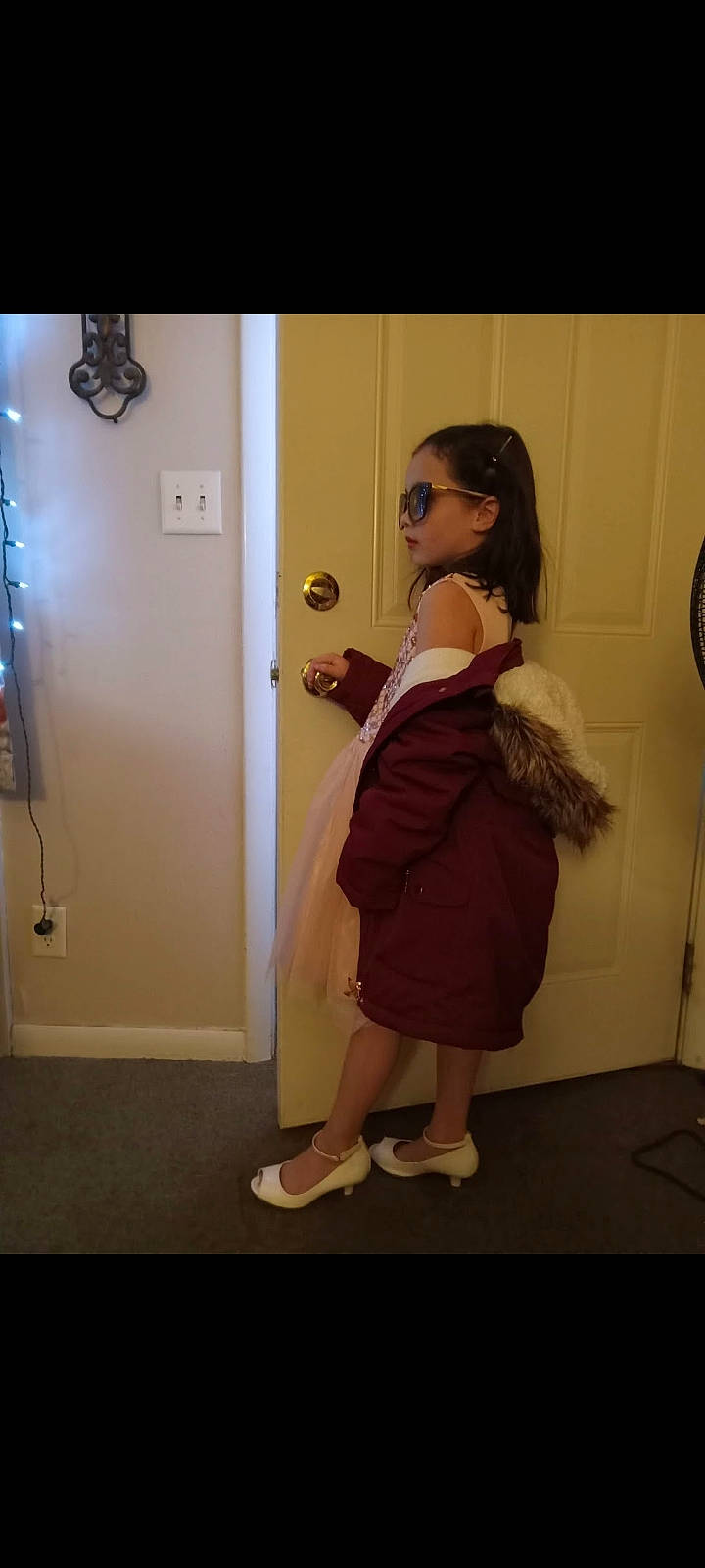 Elli is registered to the contest to win money with this photo: day_dress, door, event, eyewear, fashion_design, flooring, foot, formal_wear, fun, human_leg, knee, leg, long_hair, magenta, one_piece_garment, person, room, sandal, selfie, toddler