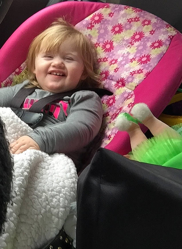 Brighton is registered to the contest to win money with this photo: baby, car_seat, child, comfort, joy, nap, person, pink, product, sitting, smile, textile, toddler, vacation