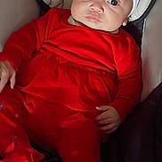 Erin'Reign joined the competition — help win amazing prizes! baby, infant, red_clothing, headband, bow, seated, cushion, indoor, portrait, cute, child, young, person, expressionless, holiday_outfit, closeup, small_hands, comfortable, soft_lighting, warm_colors