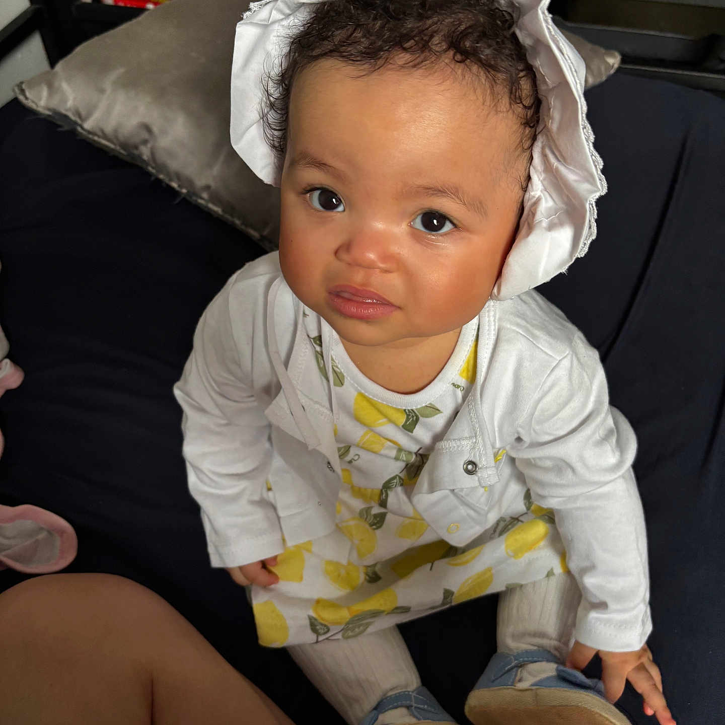 Caliyah joined the competition — help win amazing prizes! baby, bodypart, bonnet, clothing, coat, couch, cushion, face, finger, footwear, furniture, hand, hat, head, homedecor, person, photography, portrait, shoe, sitting