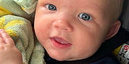 Deegan is registered to the contest to win money with this photo: baby, child, infant, face, blue_eyes, blanket, car_seat, smile, skin, arm, clothing, seatbelt, comfort, cute, portrait, indoors, young, soft_texture, happy, closeup