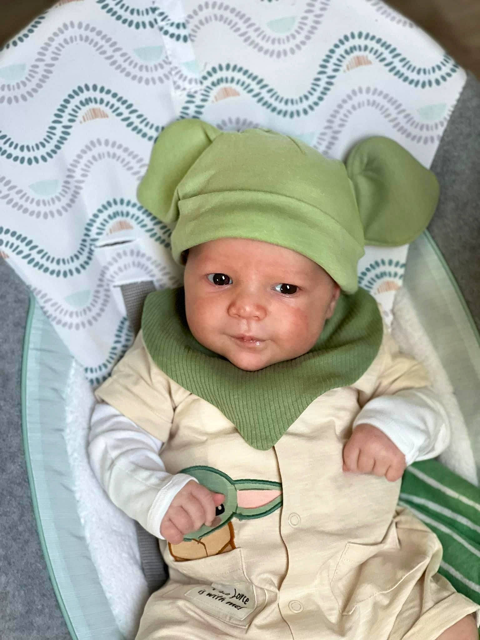 Killian joined the competition — help win amazing prizes! baby, baby_products, baby_safety, baby_toddler_clothing, beanie, cap, cheek, child, comfort, costume_hat, eye, fashion_accessory, fun, grass, headwear, knit_cap, linens, pattern, person, sitting