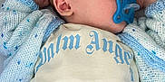 Creed is registered to the contest to win money with this photo: baby, sleeping, pacifier, blue, cardigan, knitted, infant, clothing, face, head, peaceful, resting, portrait, child, soft, texture, comfort, cute, closeup, indoors