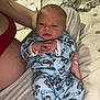Creed is registered to the contest to win money with this photo: baby, newborn, infant, pajamas, blue_clothing, cute, child, person, bed, blanket, adult_arm, hand, foot, indoor, sleepwear, soft_lighting, portrait, resting, closeup, cozy