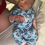 Creed is registered to the contest to win money with this photo: baby, sleeping, pajamas, blue, infant, bed, person, hand, foot, sleep, cute, newborn, clothing, pattern, train, soft, rest, human, skin, comfort