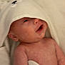 William is registered to the contest to win money with this photo: baby, infant, towel, hooded_towel, smiling, skin, cute, child, newborn, face, expression, soft, warm, indoors, person, blanket, animal_ears, happy, cozy, wrapped