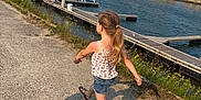 Taïss participe au concours pour gagner de l'argent avec cette photo : blue_sky, boats, buildings, casual_clothing, child, concrete, dock, fence, flowers, girl, harbor, marina, outdoor, pony_tail, sandals, shadow, skipping, summer, sunny, water
