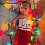 baby, infant, christmas_stocking, holiday_lights, ornaments, red, white, blanket, cute, festive, toddler, face, child, decorations, christmas, warm, soft, lying_down, celebration, holiday