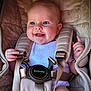 baby, infant, car_seat, harness, smiling, happy, face, blue_eyes, clothing, bracelet, sitting, child, cute, closeup, cushion, seatbelt, straps, person, indoor, portrait