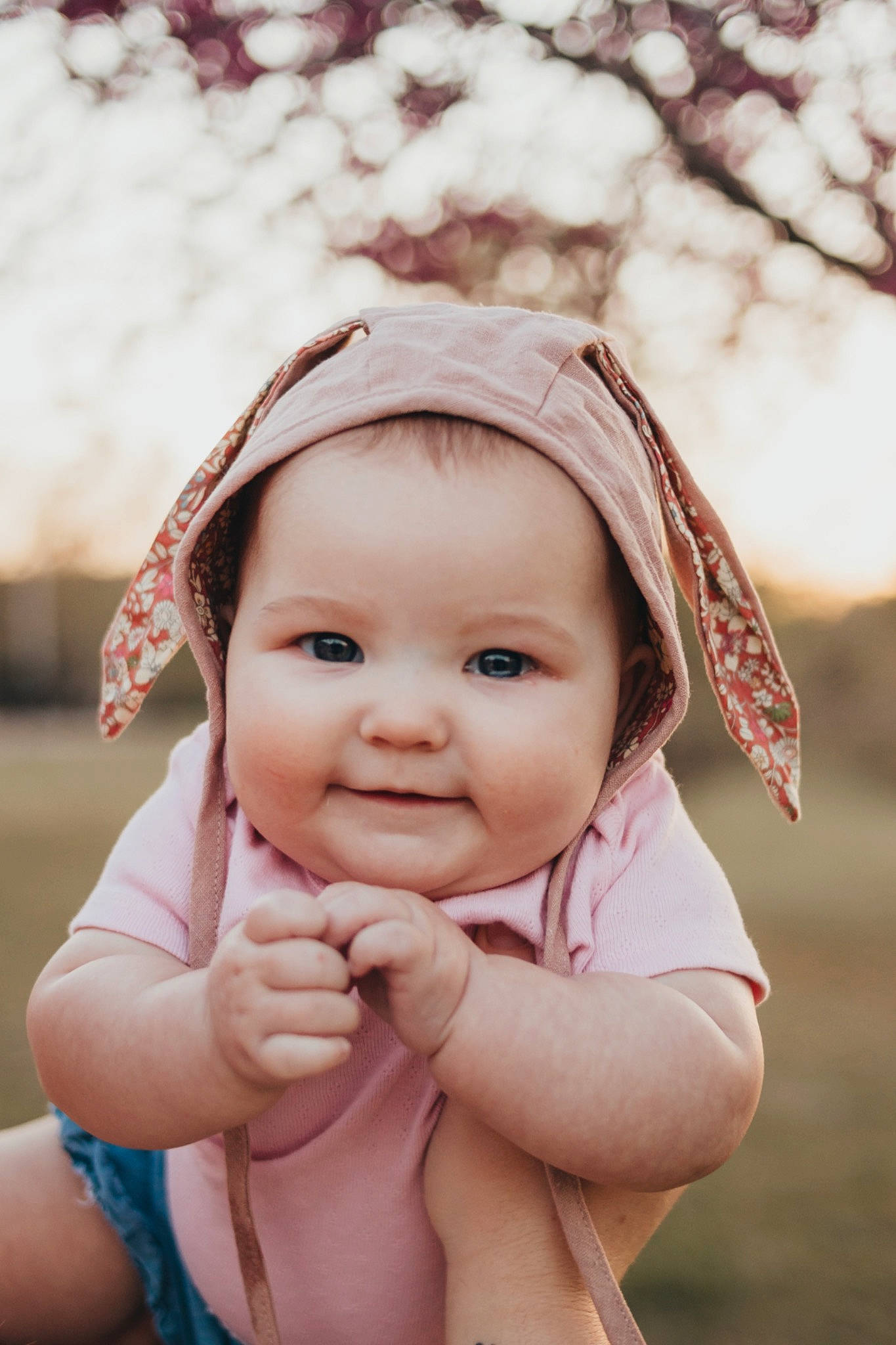 Matilda is registered to the contest to win money with this photo: arm, baby, beauty, cheek, eye, flash_photography, fun, gesture, grass, happy, iris, joy, leisure, lip, nose, people_in_nature, person, pink, skin, smile