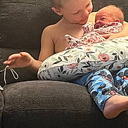 Kristine joined the competition — help win amazing prizes! child, baby, couch, pillow, floral_pattern, pacifier, smile, bare_chest, blue_pants, infant, family, indoor, love, sitting, holding, young_child, cozy, cute, toddler, comfort