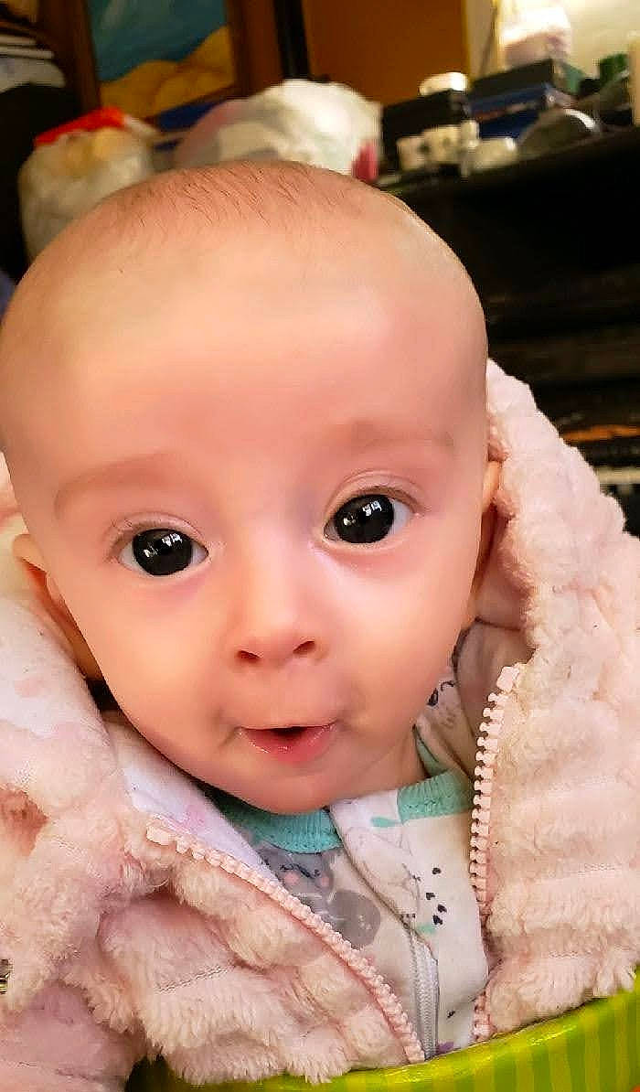 Kaiah is registered to the contest to win money with this photo: baby, baby_toddler_clothing, cheek, child, chin, close_up, collar, eye, eyelash, finger, fur, happy, iris, lip, mouth, nose, person, skin, sleeve, smile