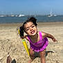 Luiza is registered to the contest to win money with this photo: child, girl, beach, sand, swimsuit, purple, water_gun, toy, smile, happy, curly_hair, pigtails, ocean, sailboats, summer, sunny, play, fun, outdoor, vacation
