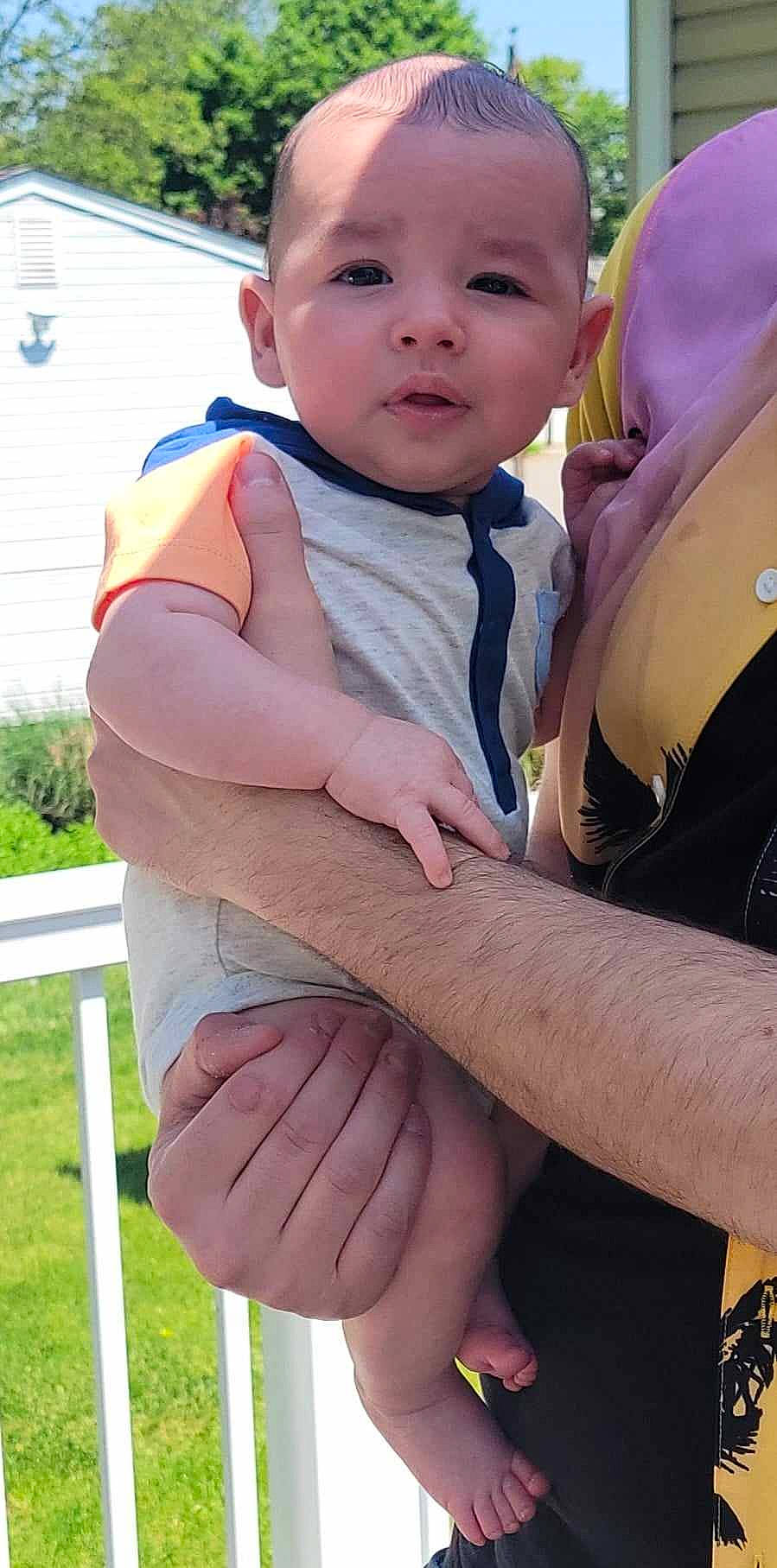 Joseph is registered to the contest to win money with this photo: baby, baby_products, baby_toddler_clothing, chest, child, elbow, finger, fun, gesture, grass, happy, leisure, nail, people_in_nature, person, pink, sitting, skin, thumb, toddler