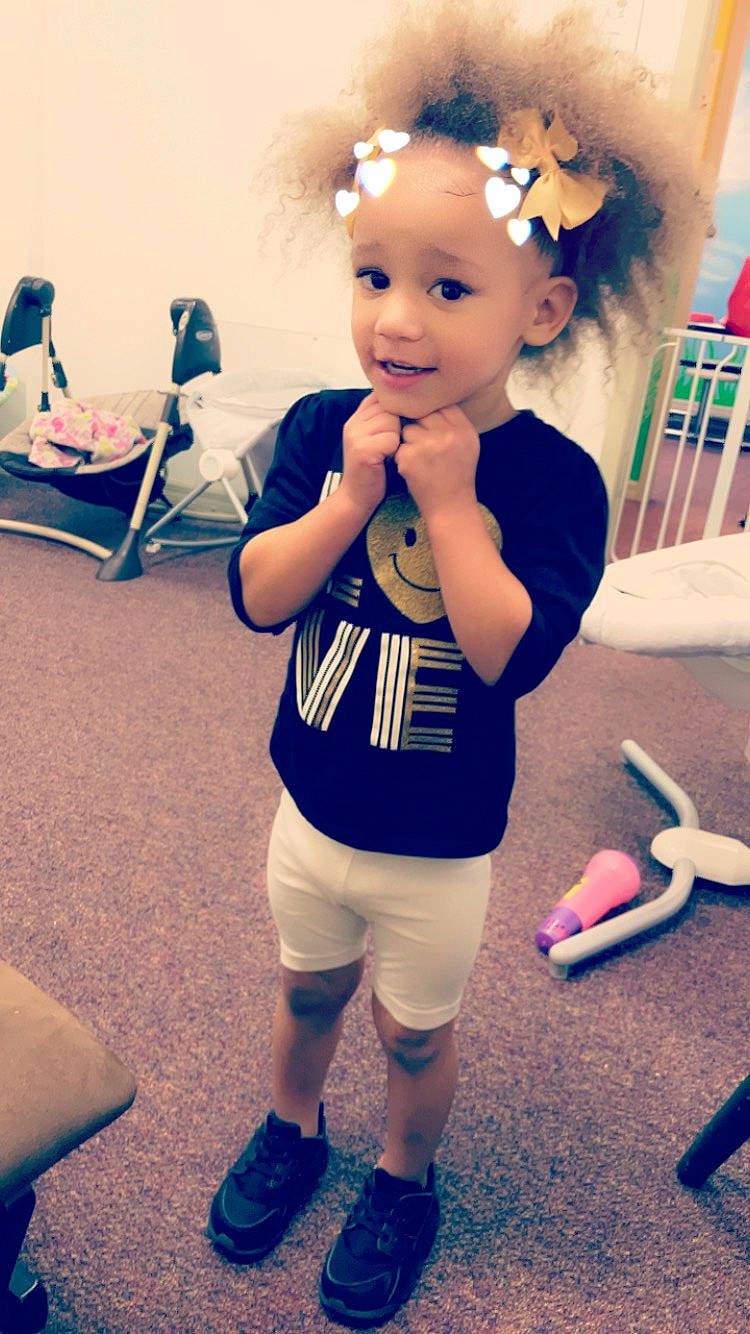 Zeniah is registered to the contest to win money with this photo: arm, blue, child, costume, day, fun, girl, hair, happiness, human_hair_color, person, product, shoe, shoulder, skin, smile, standing, toddler