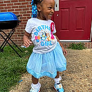 Aubrey joined the competition — help win amazing prizes! child, birthday, girl, blue_tutu, sneakers, beads, hair, smile, outdoor, brick_wall, door, grass, concrete, grill, tshirt, celebration, happy, person, playful, fashion