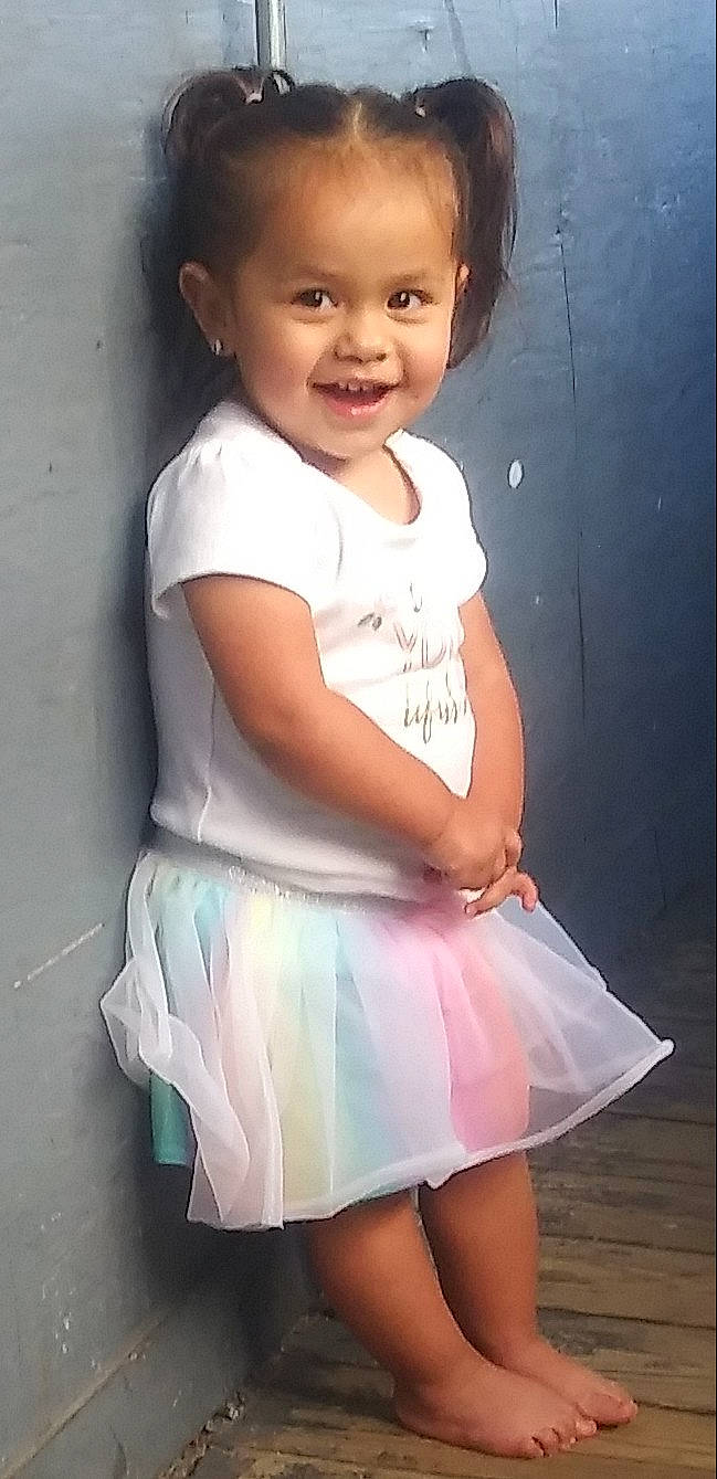 Giselle is registered to the contest to win money with this photo: baby, baby_toddler_clothing, cheek, child, child_model, cocktail_dress, day_dress, embellishment, facial_expression, hairstyle, happy, iris, joy, laugh, one_piece_garment, person, pink, silver, skin, standing