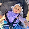 baby, baby_accessories, blue_eyes, child, clothing, comfort, cute, denim_pants, happy, infant, outdoor, pacifier, person, purple_vest, seatbelt, smile, stroller, sunlight, toy, white_hat