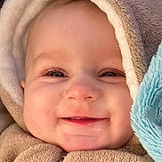 Justine participe au concours pour gagner de l'argent avec cette photo : apparel, baby, cheeks, child, closeup, cozy, cute, eyelashes, face, happy, hood, infant, nose, plush_toy, portrait, skin, smiling, soft_texture, warm_clothing, zipped_jacket