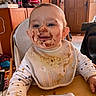 Justine a rejoint le concours — aidez-le/la à gagner de superbes lots ! baby, bib, bottle, child, chocolate, clothing, cute, face_paint, furniture, happy, high_chair, home, indoor, infant, messy, person, sitting, smiling, table, wooden_door