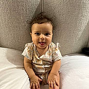 Tasnim a rejoint le concours — aidez-le/la à gagner de superbes lots ! baby, bed, child, clothing, cute, fabric, furniture, hand, happy, headboard, indoors, infant, person, pillow, portrait, sitting, skin, smiling, tongue_out, young_child