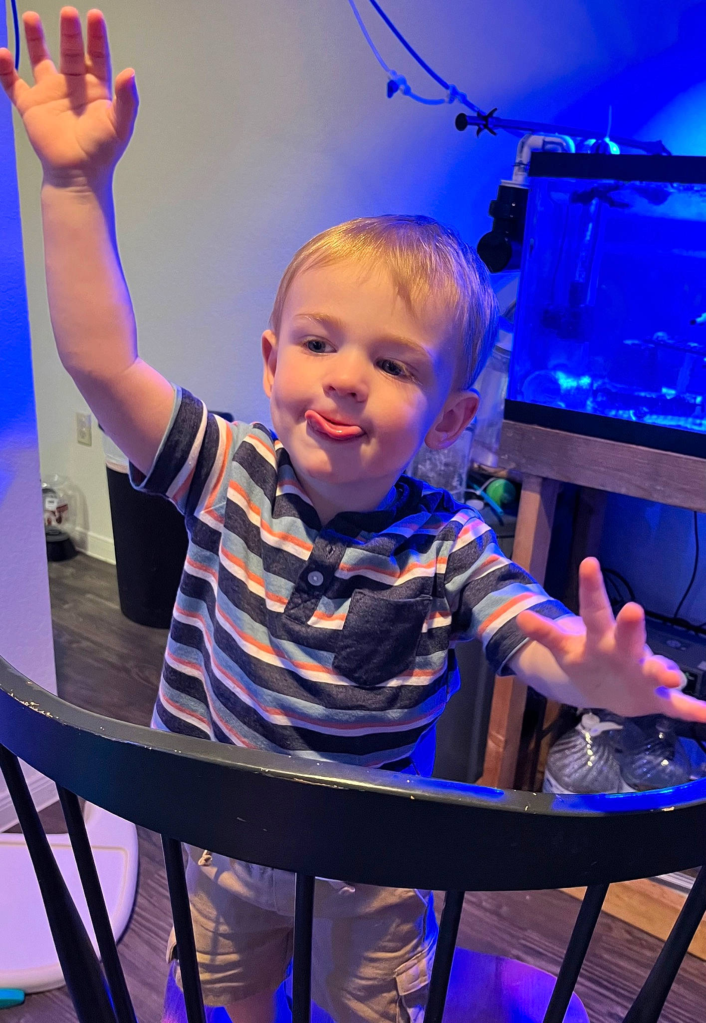 Cody is registered to the contest to win money with this photo: blue, chair, electric_blue, entertainment, event, fun, gesture, happy, leisure, music, music_artist, musician, performance, performing_arts, person, purple, smile, standing, t_shirt, table