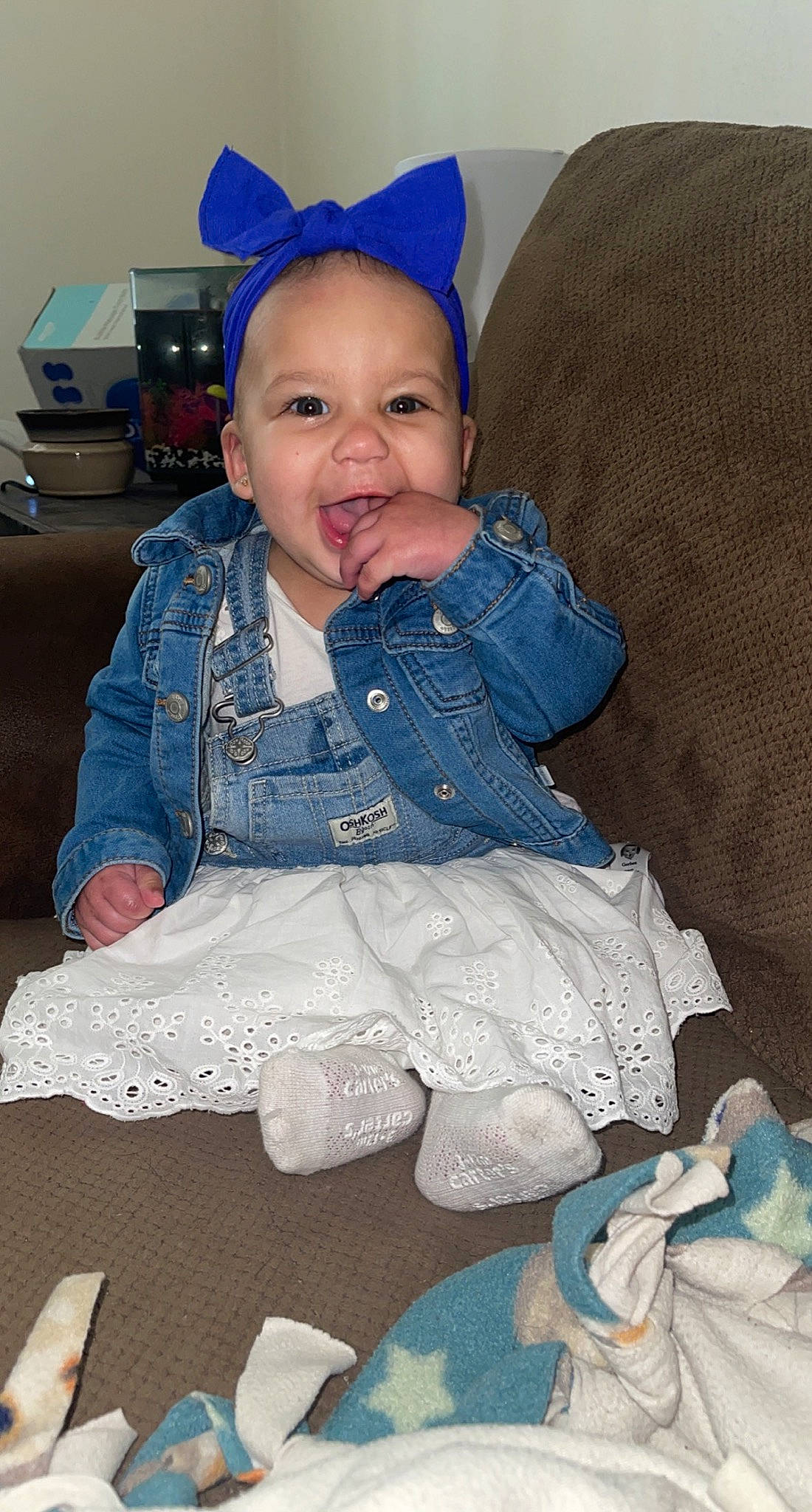 Ohana is registered to the contest to win money with this photo: baby, baby_products, baby_toddler_clothing, blue, cheek, child, comfort, happy, iris, linens, pattern, person, product, room, sitting, skin, sleeve, smile, textile, toddler