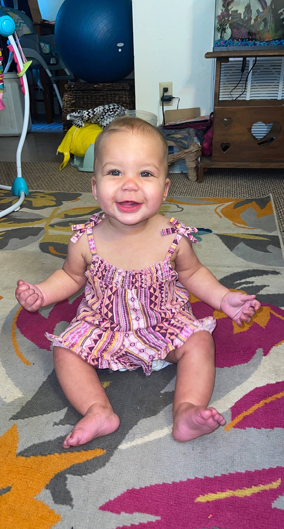 Ohana is registered to the contest to win money with this photo: baby, baby_toddler_clothing, cheek, child, facial_expression, floor, flooring, fun, happy, head, iris, joy, mouth, person, pink, product, purple, skin, smile, summer
