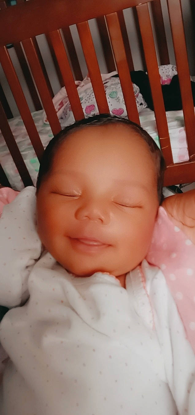 Graclynn is registered to the contest to win money with this photo: baby, baby_toddler_clothing, cheek, chin, eye, face, facial_expression, finger, iris, lip, mouth, nose, organ, person, pink, product, skin, sleeve, smile, thumb