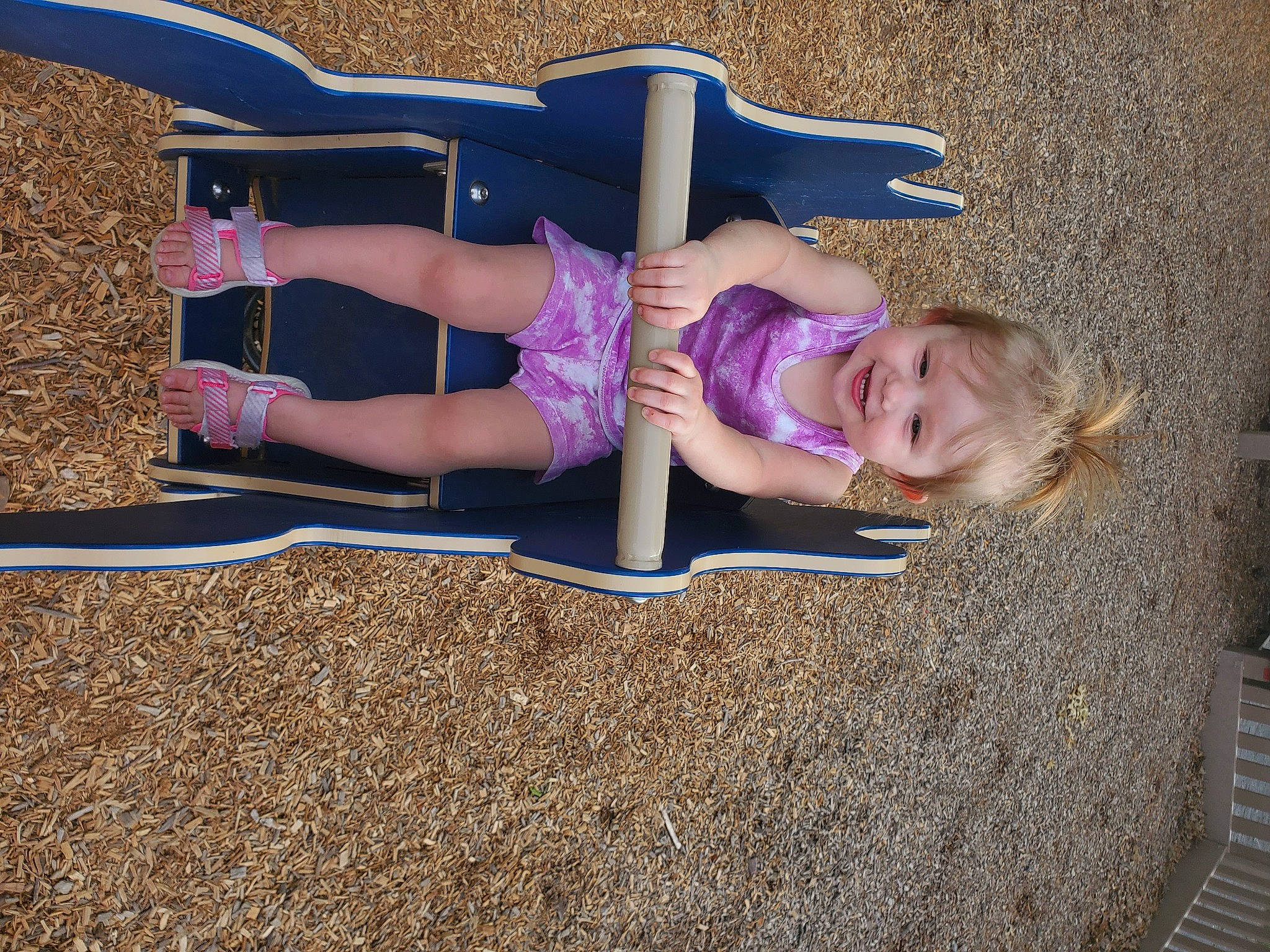 Michaela is registered to the contest to win money with this photo: blond, calf, child, city, electric_blue, fun, grass, human_leg, joy, knee, leisure, magenta, person, pink, purple, recreation, sand, sitting, smile, thigh