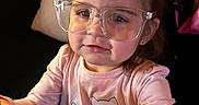 Sariyah joined the competition — help win amazing prizes! toddler, child, glasses, pink_shirt, cartoon_cats, indoor, couch, curious, reaching, person, portrait, cute, young_child, long_sleeves, home, smiling, face, hair, earrings, light