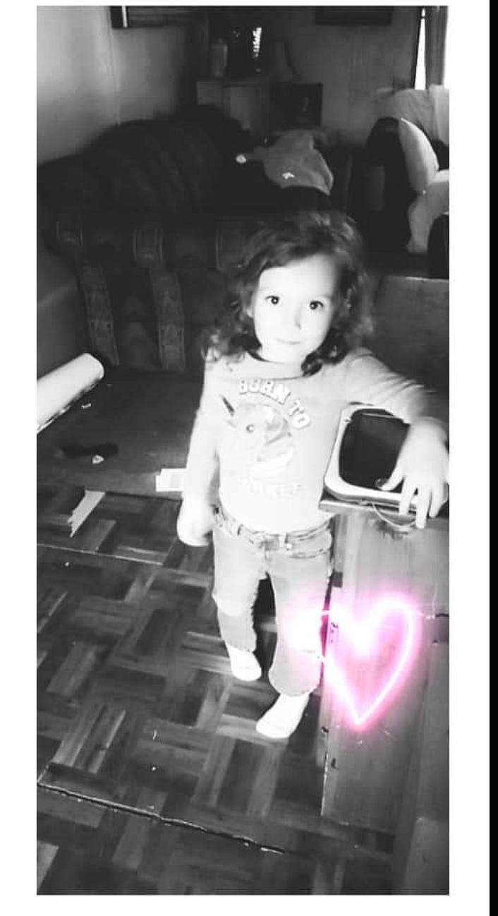 Ireland is registered to the contest to win money with this photo: black_and_white, child, cool, doll, electronic_device, entertainment, fashion_design, flash_photography, font, fun, happy, human_body, monochrome, monochrome_photography, person, photo_caption, room, sitting, style, technology