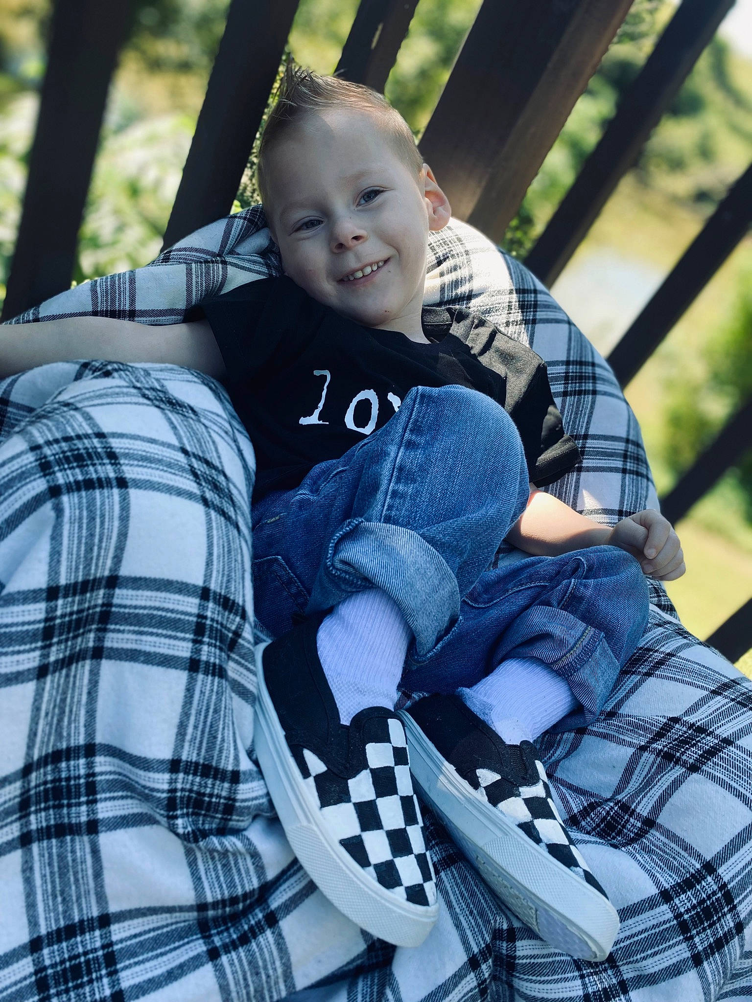 Weston Duncan is registered to the contest to win money with this photo: arm, baby, baby_carriage, baby_products, baby_toddler_clothing, comfort, cool, electric_blue, grass, happy, human, joy, leisure, outerwear, pattern, people_in_nature, person, plaid, sleeve, smile