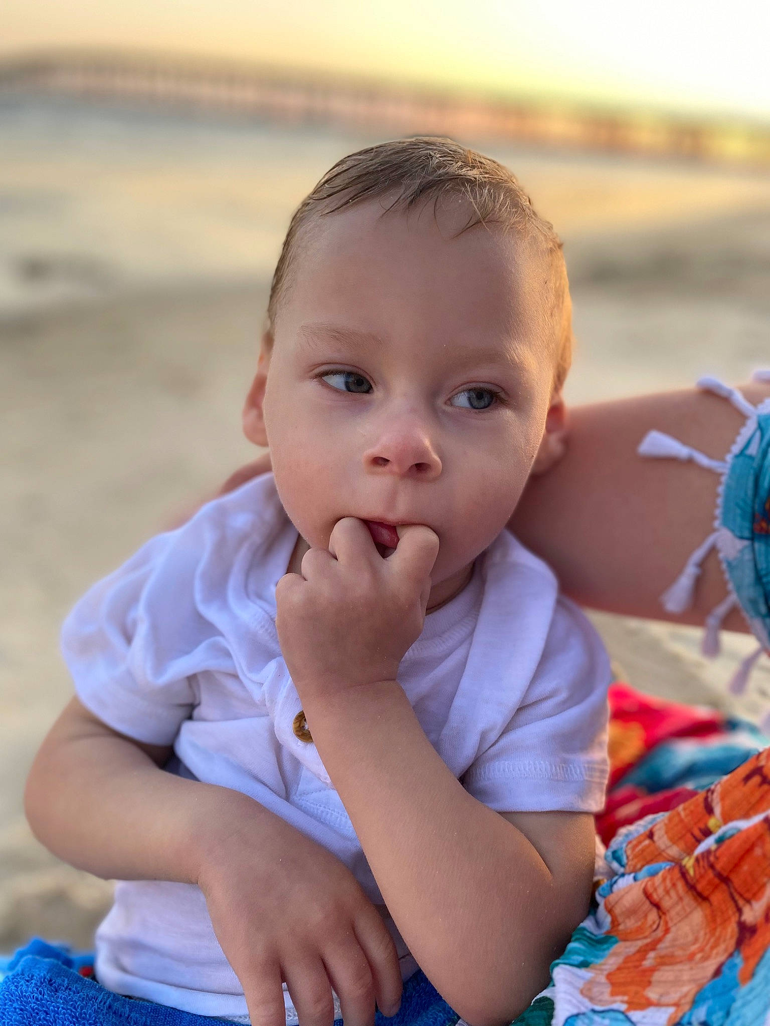 Weston Duncan is registered to the contest to win money with this photo: baby, baby_toddler_clothing, beach, blue, child, finger, fun, grass, happy, iris, leisure, nose, ocean, people_in_nature, person, recreation, sand, sitting, skin, toddler