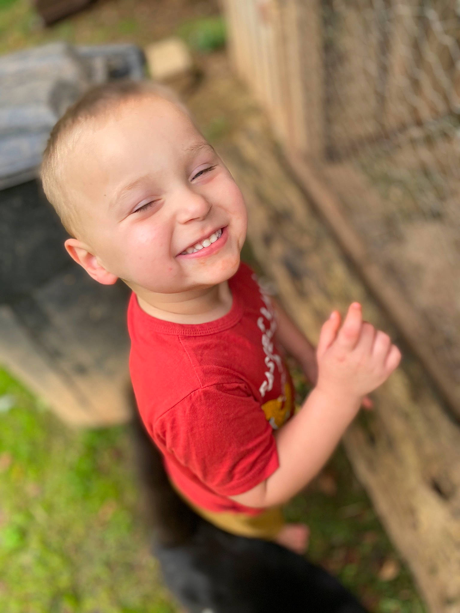 Winston is registered to the contest to win money with this photo: child, flash_photography, fun, gesture, grass, happy, joy, laugh, leisure, lip, people_in_nature, person, plant, recreation, sitting, skin, smile, soil, t_shirt, toddler