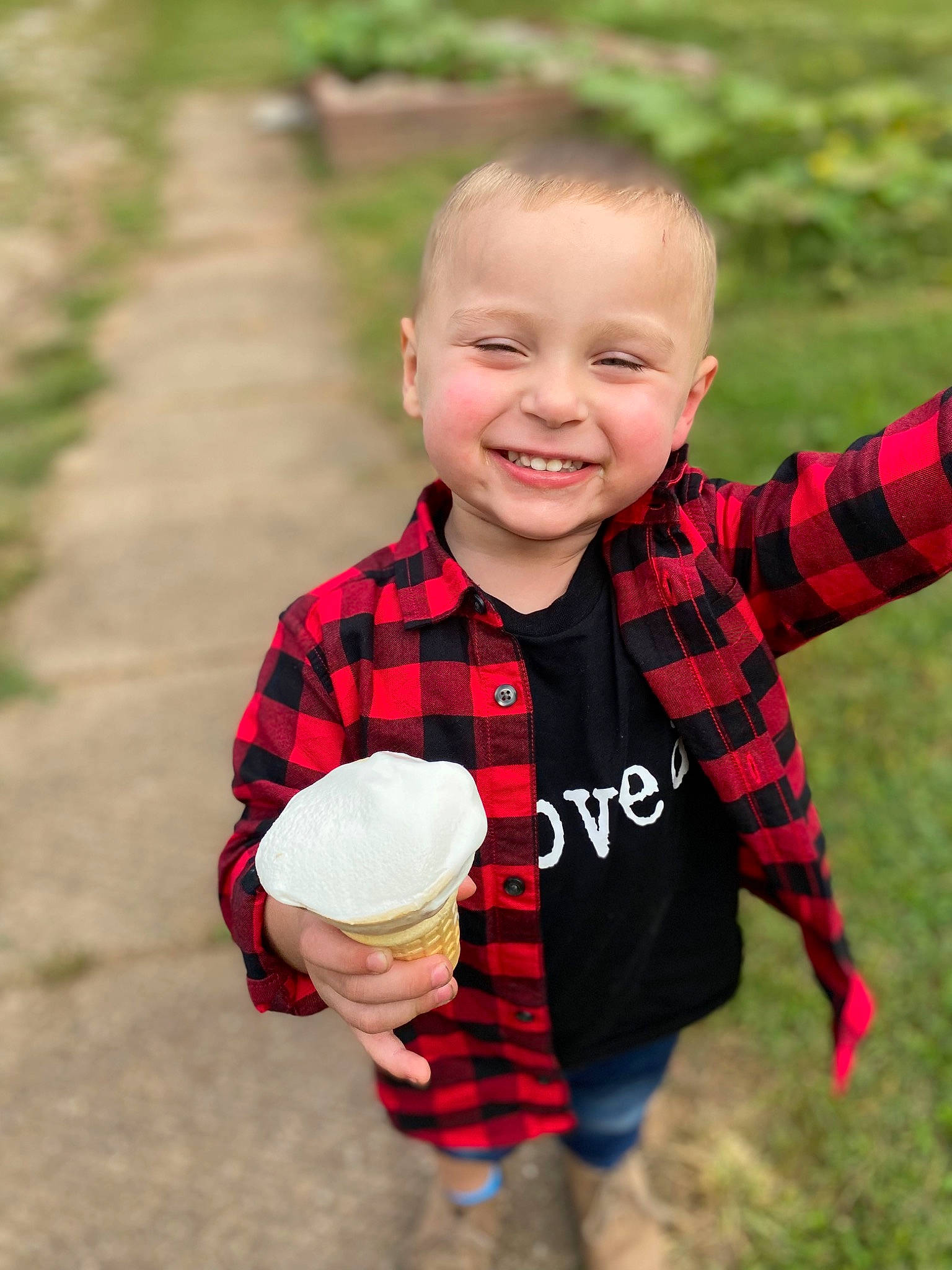 Winston joined the competition — help win amazing prizes! child, dairy, finger, food, fun, gesture, grass, happy, joy, pattern, people_in_nature, person, plaid, plant, play, sitting, sleeve, smile, soil, tartan