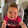 Wrenlee is registered to the contest to win money with this photo: baby, child, smiling, high_chair, pink_shirt, nike, girl_power, indoor, face, hands, cute, happy, person, portrait, young_child, infant, seated, clothing, expression, hair